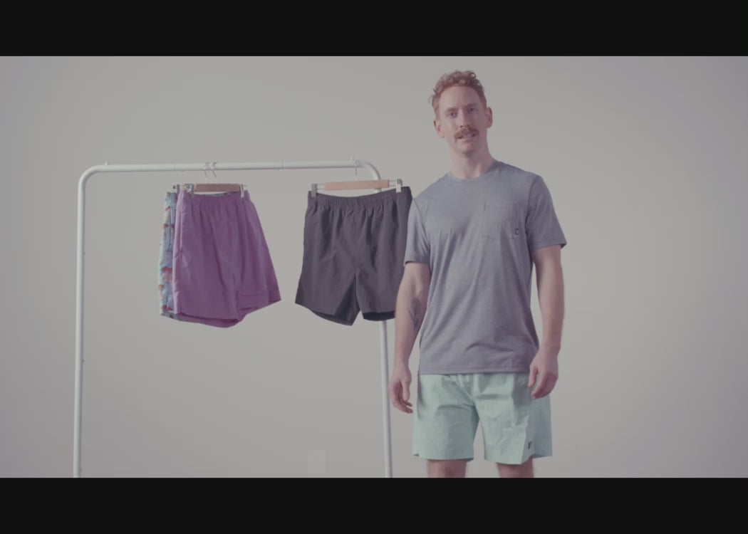 A Man standing in front of a clothing rack, with various Go Coastal colourways hanging