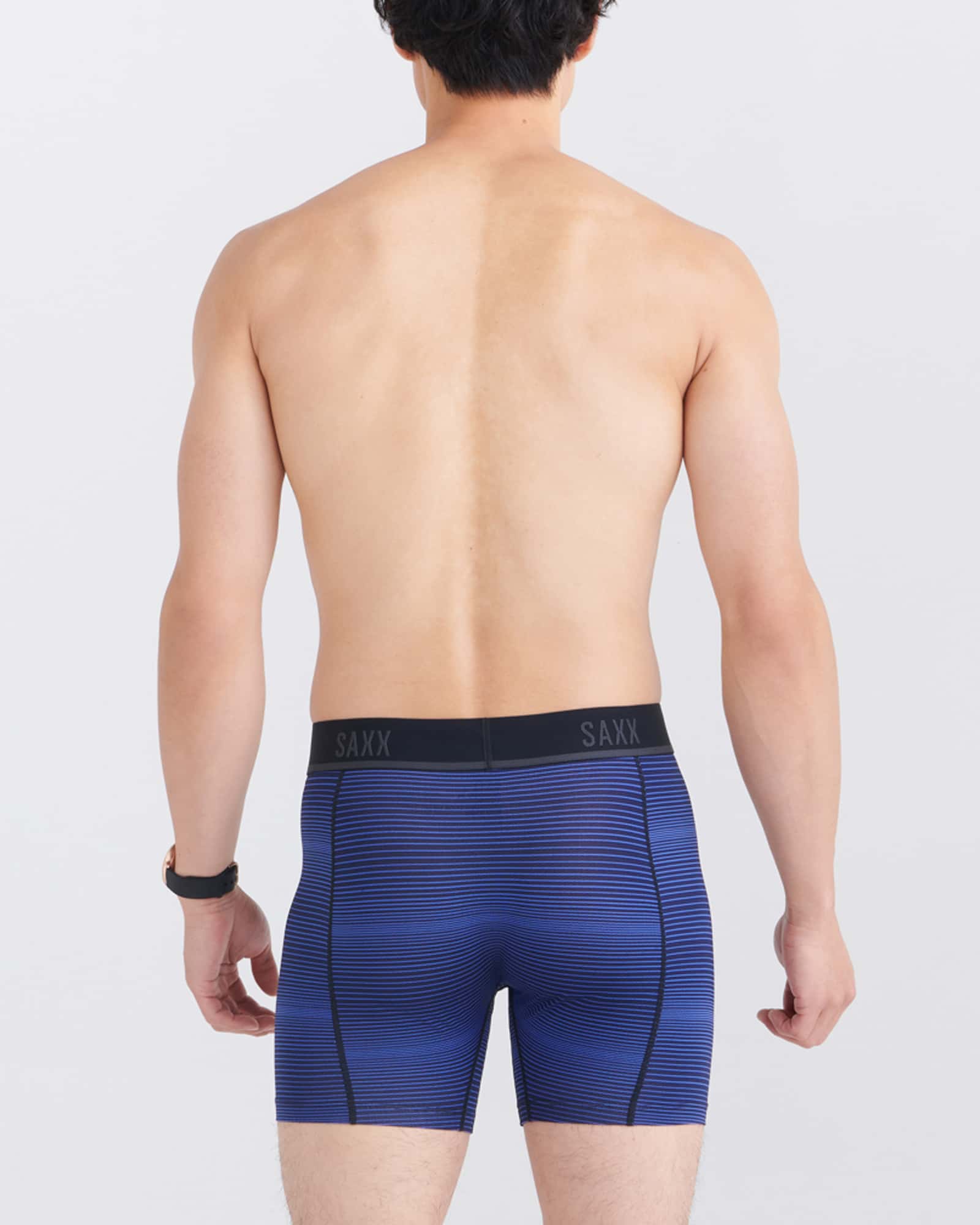 Back - Model wearing Kinetic Light-Compression Mesh Boxer Brief in Variegated Stripe- Blue