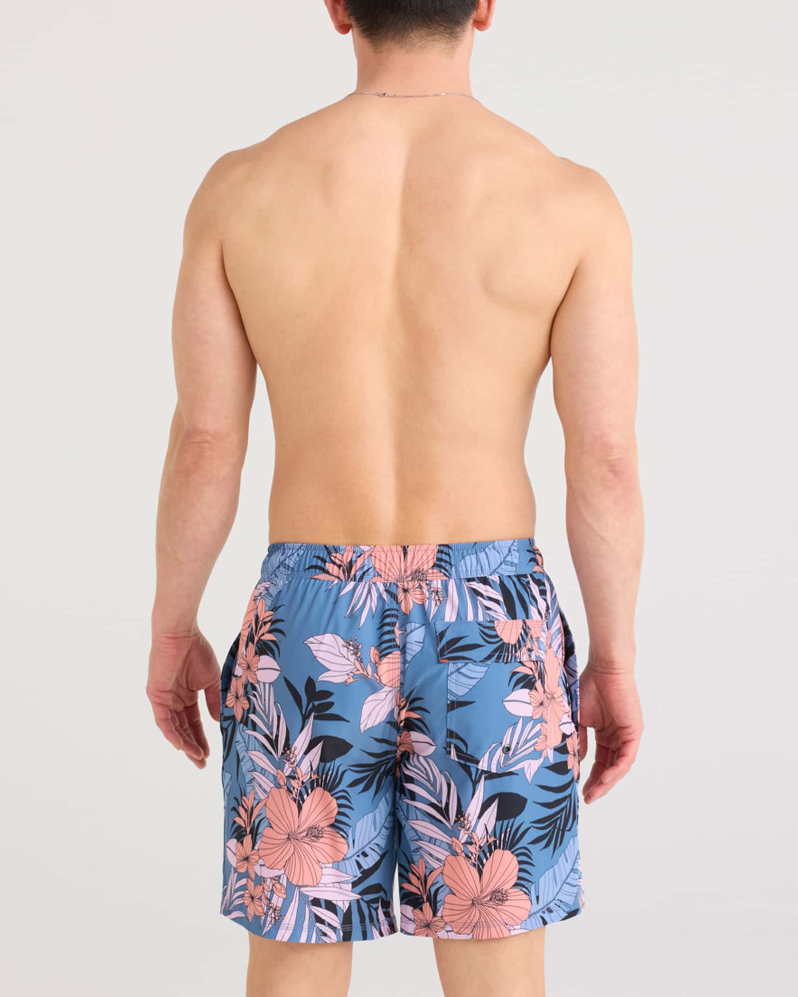 Back - Model wearing Oh Buoy 2N1 Swim Short in Hibiscus Jungle-Blue