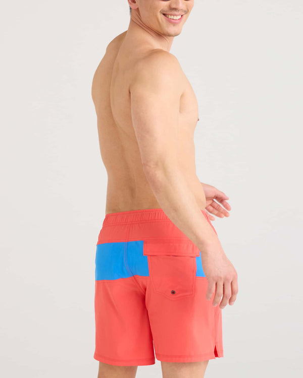 Back - Model wearing Oh Buoy 2N1 Swim Volley 7" in Coral Red/Racer Blue